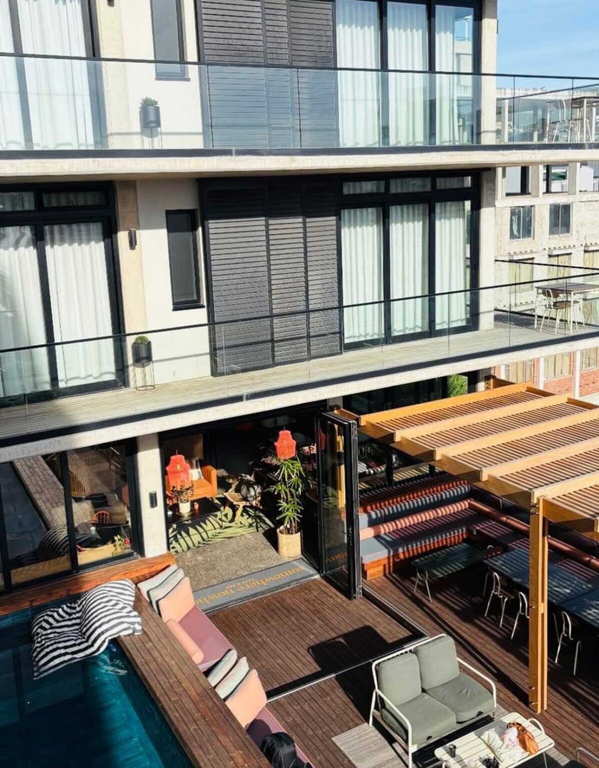 The Somewhere Nowhere rooftop deck, pool and striped awnings at 84 Harrington Street